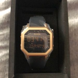 Black and gold Nixon watch